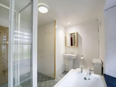 a bathroom with a sink and a toilet and a shower at St Peters Cottage in Port Isaac