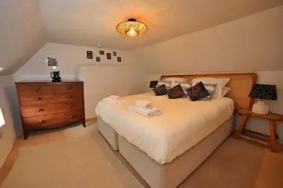 a bedroom with a bed with two towels on it at Finest Retreats - Old Lanvean Cottage in Saint Mawgan