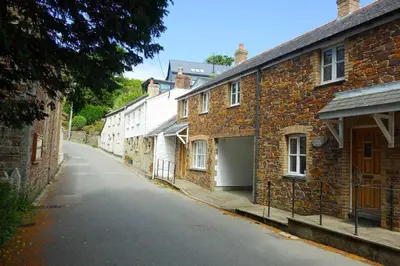 an empty street in front of brick buildings at Finest Retreats - Old Lanvean Cottage in Saint Mawgan