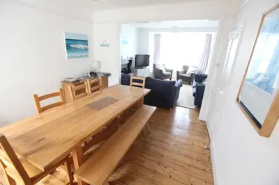 a living room with a wooden table and a couch at Sea Haven in Port Isaac
