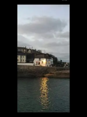 a view of a body of water with buildings and houses at Small self contained room in Porthleven