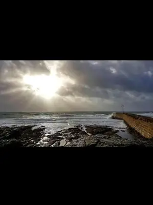 a view of the ocean with the sun in the sky at Small self contained room in Porthleven