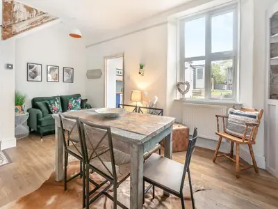 a living room with a table and chairs at Lanner Moon in Carnbrea
