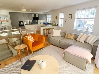a living room with a couch and a table at Sea La Vie in St Ives