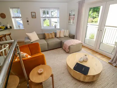 a living room with a couch and a table at Sea La Vie in St Ives