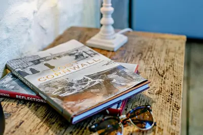 two books sitting on a table with a pair of glasses at 1 Bed in St. Ives oc-e28023 in St Ives