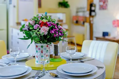 a table with a vase of flowers on top of it at 1 Bed in St. Ives oc-e28023 in St Ives