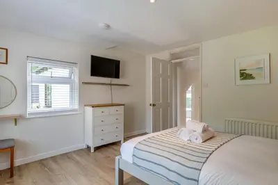 a bedroom with a bed and a tv on the wall at 5 Bed in Bodmin oc-l29658 in Blisland