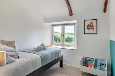 a bedroom with a bed and a window at 5 Bed in Bodmin oc-l29658 in Blisland