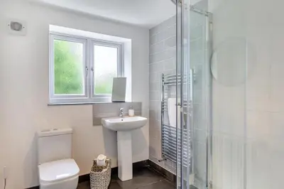 a bathroom with a toilet and a sink and a shower at 5 Bed in Bodmin oc-l29658 in Blisland
