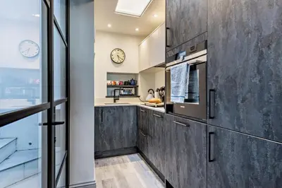 a kitchen with a counter and a clock on the wall at 3 Bed in Fowey oc-p29280 in Fowey