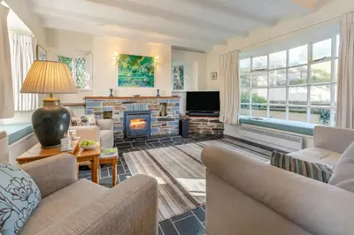 a living room with couches and a fire place at 3 Bed in St. Minver oc-c29337 in Saint Minver
