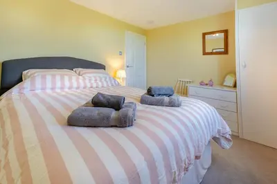 a bedroom with a bed with two pillows on it at 3 Bed in St. Minver oc-c29337 in Saint Minver