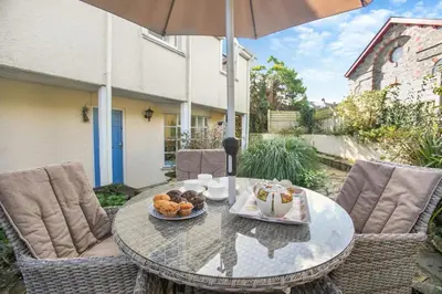 a table with a plate of food on a patio at 3 Bed in St. Minver oc-c29337 in Saint Minver