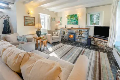 a living room with a couch and a fireplace at 3 Bed in St. Minver oc-c29337 in Saint Minver