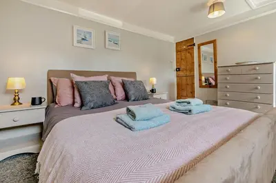 a bedroom with a large bed with two towels on it at 2 Bed in Delabole oc-r29780 in Delabole