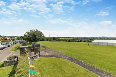 a view of a field with cars parked on a road at 2 Bed in Delabole oc-r29780 in Delabole