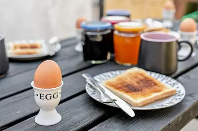 a table with an egg and a plate of toast at 2 Bed in Delabole oc-r29780 in Delabole