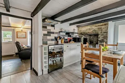 a kitchen and dining room with a table and a stove at 2 Bed in Delabole oc-r29780 in Delabole
