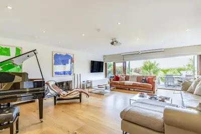 a living room with a piano and a couch at 4 Bed in Mawgan Porth oc-h29763 in Mawgan Porth