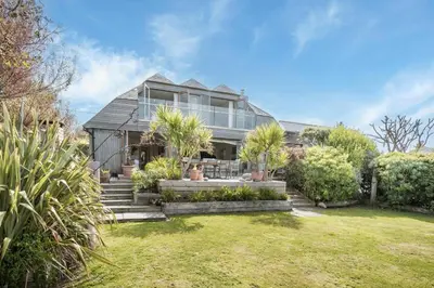 an exterior view of a house with a yard at 4 Bed in Mawgan Porth oc-h29763 in Mawgan Porth