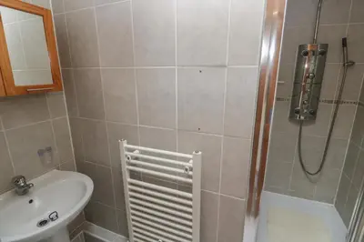 a bathroom with a shower and a sink and a sink at Horseshoe Cottage in Newquay