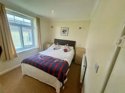 a small bedroom with a bed and a window at 79 Atlantic Reach in Newquay