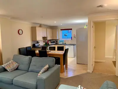 a kitchen and living room with a couch and a table at 79 Atlantic Reach in Newquay