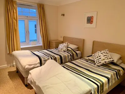 a room with two beds and a window at 79 Atlantic Reach in Newquay