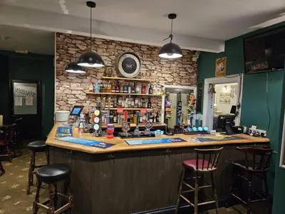 a bar in a restaurant with stools at St aubyn arms Hotel in Praze an Beeble