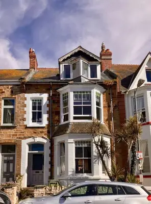 a house with a car parked in front of it at Flip Flop Flat, Sea Views, Short Stroll to Beaches in Newquay