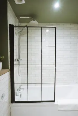 a bathroom with a shower and a bath tub at Stunning High Street Townhouse With Sea Views & Parking at 'Tide View Townhouse' in Falmouth