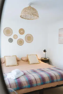 a bedroom with a bed with a colorful blanket at Stunning High Street Townhouse With Sea Views & Parking at 'Tide View Townhouse' in Falmouth