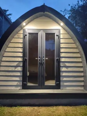 a gazebo with a door in the middle at Beautiful and Cosy Garden Pod Saintives in Carbis Bay