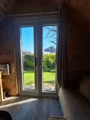 a room with a window with a view of a door at Beautiful and Cosy Garden Pod Saintives in Carbis Bay