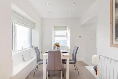 a white dining room with a table and chairs at 2 Bed in Porthleven oc-m28188 in Porthleven