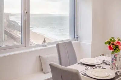 a dining room with a table with a view of the ocean at 2 Bed in Porthleven oc-m28188 in Porthleven