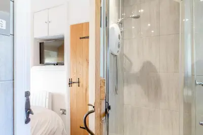 a bathroom with a shower with a glass door at 2 Bed in Porthleven oc-m28188 in Porthleven