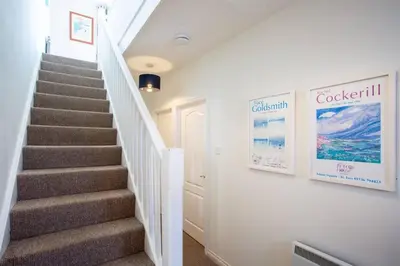a staircase in a home with white walls and staircasesafety at Tredreath, Manor Cottages in Falmouth