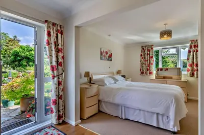 a bedroom with a bed and a large window at 2 Bed in Ruan High Lanes oc-r29865 in Ruan Lanihorne
