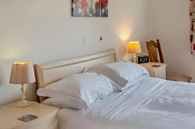 a bed with white sheets and pillows in a bedroom at 2 Bed in Ruan High Lanes oc-r29865 in Ruan Lanihorne
