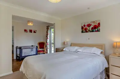 a bedroom with a large white bed and a chair at 2 Bed in Ruan High Lanes oc-r29865 in Ruan Lanihorne