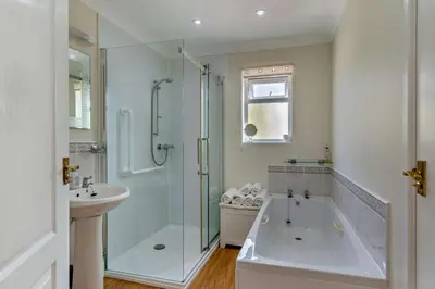 a bathroom with a shower and a tub and a sink at 2 Bed in Ruan High Lanes oc-r29865 in Ruan Lanihorne