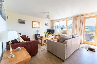 a living room with two couches and a table at 3 Bed in Goldenbank oc-c29977 in Falmouth