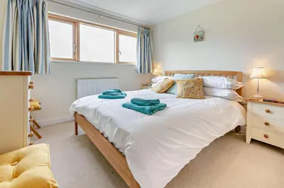 a bedroom with a large white bed with blue towels on it at 3 Bed in Goldenbank oc-c29977 in Falmouth
