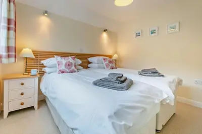 a bedroom with two beds with towels on them at 3 Bed in Goldenbank oc-c29977 in Falmouth