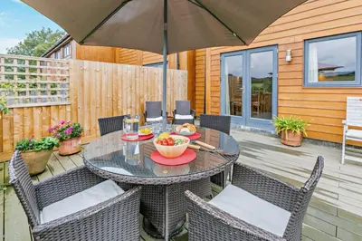 a patio with a table and chairs and an umbrella at 3 Bed in Goldenbank oc-c29977 in Falmouth