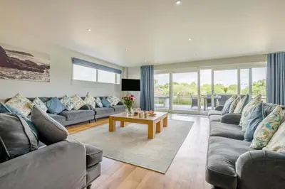a living room with two couches and a table at 6 Bed in Winnards Perch oc-t29966 in Saint Columb Major