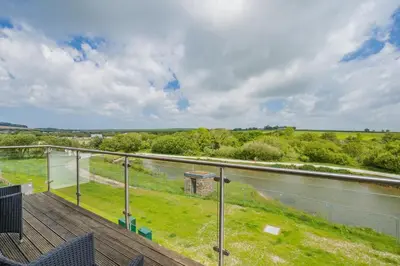 a balcony with a view of a river at 6 Bed in Winnards Perch oc-t29966 in Saint Columb Major
