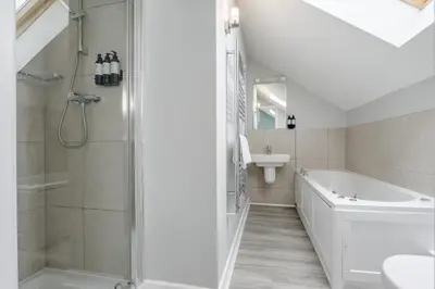 a bathroom with a shower and a tub and a sink at 6 Bed in Winnards Perch oc-t29966 in Saint Columb Major